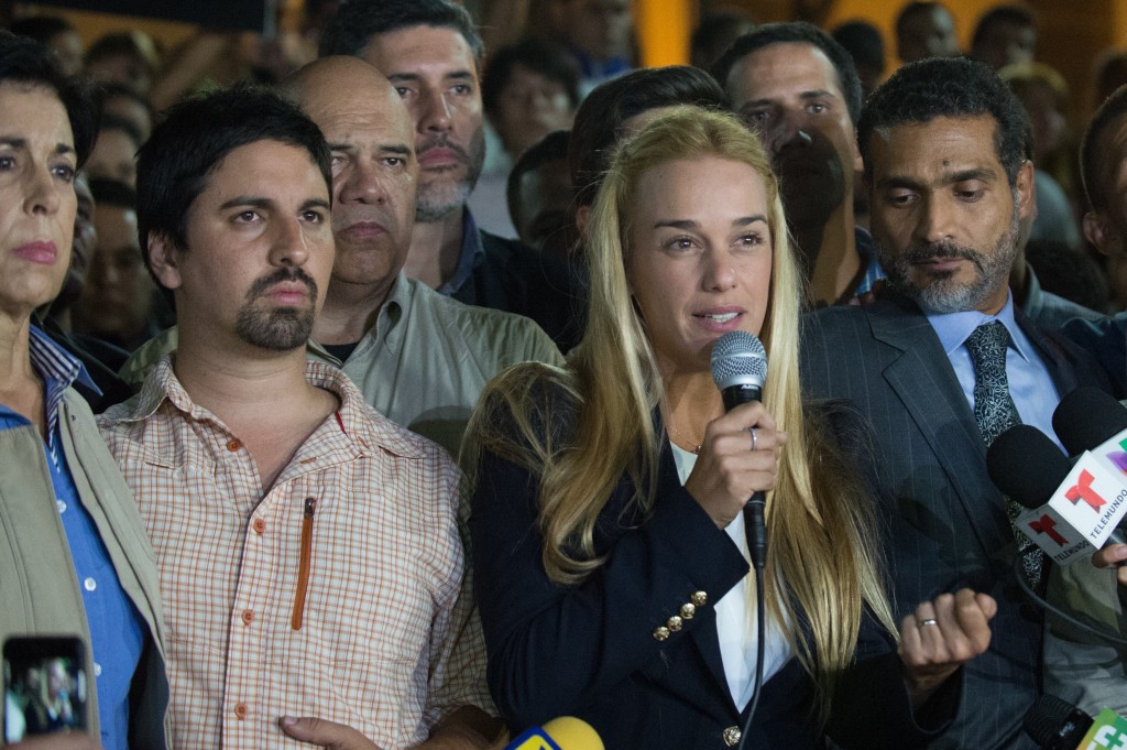 The wife of jailed opposition leader Leopoldo Lopez, Lilian Tintori (2-R) talks during press conference in Caracas on September 10, 2015. Jailed Venezuelan opposition leader Leopoldo Lopez was sentenced to nearly 14 years in prison for inciting violence during deadly protests in 2014. The popular dissident, a US-trained economist who has been held at a military prison since February 2014, is accused of inciting violence against the government of President Nicolas Maduro and attempting to force his ouster. AFP PHOTO/ FEDERICO PARRA