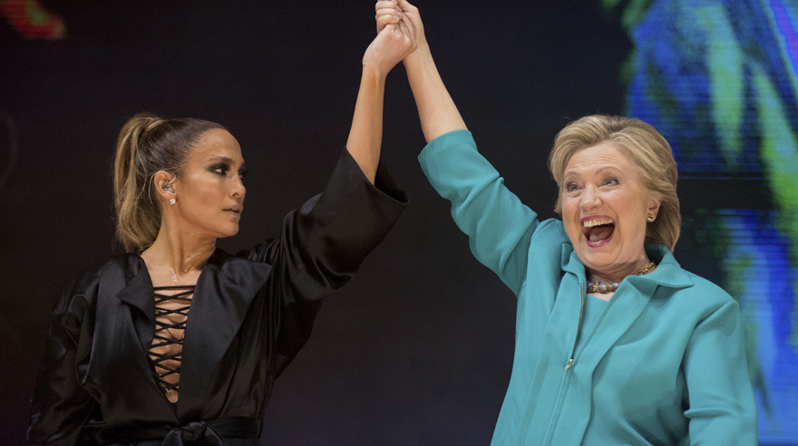 Democratic presidential candidate Hillary Clinton, right, takes the stage with performer Jennifer Lopez, left, at a Get Out The Vote performance at Bayfront Park Amphitheater in Miami, Saturday, Oct. 29, 2016. (AP Photo/Andrew Harnik)
