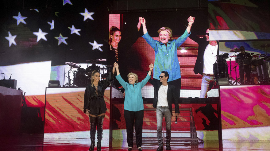 Democratic presidential candidate, Hillary Clinton, center, stands with performer Jennifer Lopez, left, and singer-songwriter, Marc Anthony, right, at a Get Out The Vote performance at Bayfront Park Amphitheater in Miami, Saturday, Oct. 29, 2016. (AP Photo/Andrew Harnik)
