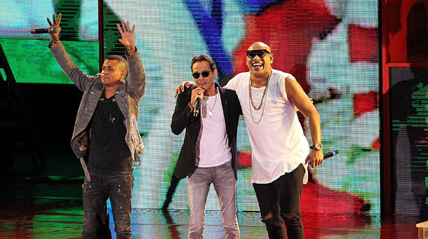Cuban artists Gente de Zona joined Marc Anthony, center, and Jennifer Lopez (not pictured), during a Get Out The Vote performance for Democratic presidential nominee, Hillary Clinton, at Bayfront Park Amphitheater in Miami, Saturday Oct. 29, 2016. (Pedro Portal/Miami Herald via AP)