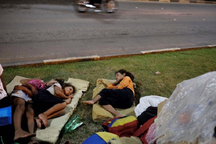 Venezuelan children sleep on the grass in front of interstate Bus Station in Boa Vista, Roraima state, Brazil August 23, 2018. Picture taken August 23, 2018. REUTERS/Nacho Doce