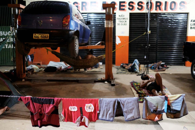 Laundry of Venezuelan people are hanging on a rope during the night at the car repair shop, near the interstate Bus Station in Boa Vista, Roraima state, Brazil August 25, 2018. Picture taken August 25, 2018. REUTERS/Nacho Doce