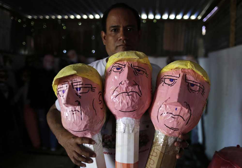 A local craftsman displays his handmade puppets of United States President Donald Trump ahead of New Year's Eve in Managua, on December 29, 2018. - The puppets, made from old clothes to represent the past year, are traditionally burned at the New Year as a way of saying goodbye to the old year and welcoming the new. (Photo by INTI OCON / AFP)