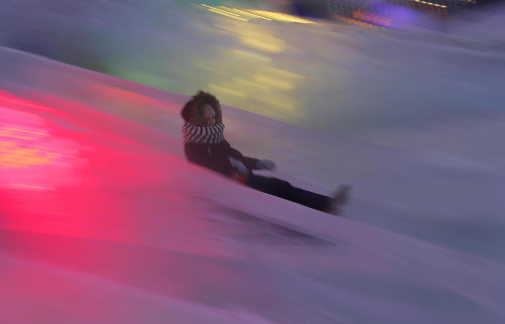 Moscow (Russian Federation), 29/12/2018.- A girl slides down a run in an ice sculpture park decorated for the New Year and Christmas holidays in Moscow, Russia, 29 December 2018. The Moscow authorities spent almost 972 million rubles (about 12 million eur) to celebrate the New Year. In total, around 4,000 designs of festive decorations and at least 250 Christmas trees were installed in Moscow. (Rusia, Moscú) EFE/EPA/SERGEI ILNITSKY