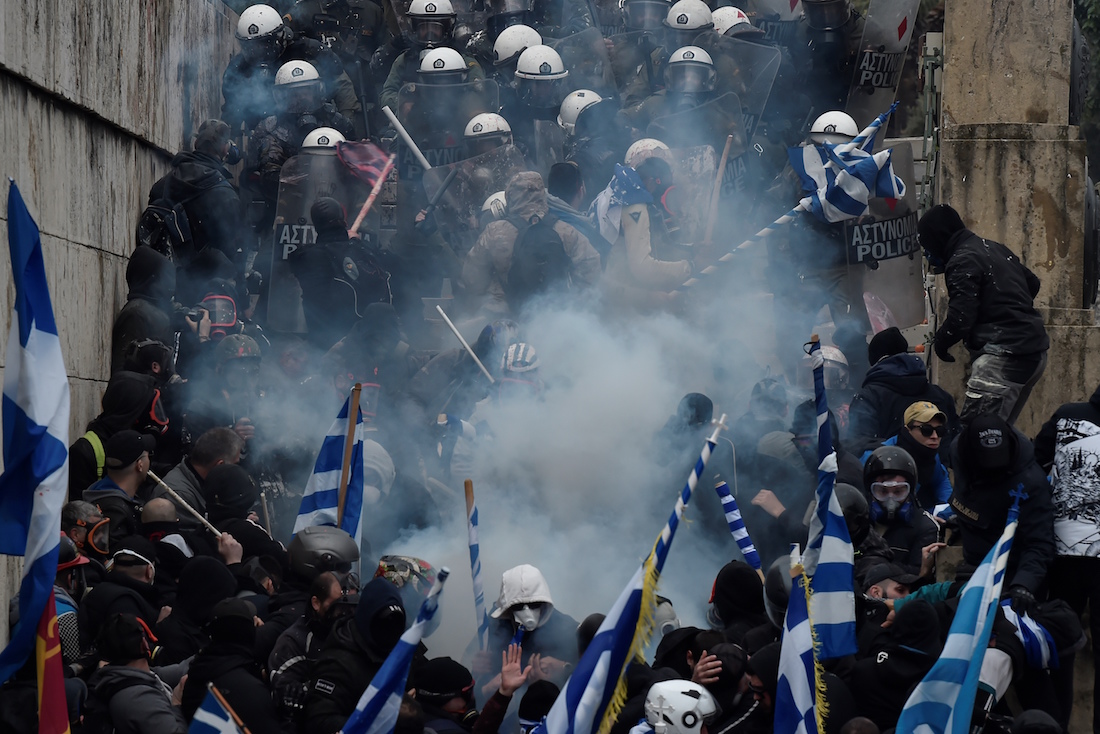 Protesters clash with police near the Greek Parliament during a demonstration against an agreement with Skopje to rename neighbouring country Macedonia as the Republic of North Macedonia, on January 20, 2019, in Athens. - The proposal faces resistance in Greece because of what critics see as the implied claims to Greek land and cultural heritage. For most Greeks, Macedonia is the name of their history-rich northern province made famous by Alexander the Great's conquests. (Photo by Louisa GOULIAMAKI / AFP)