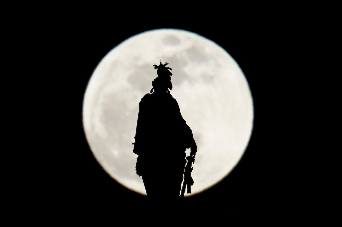The Statue of Freedom on top of the US Capitol dome is seen silhouetted against the super moon on January 20, 2019 in Washington, DC. (Photo by Brendan Smialowski / AFP)