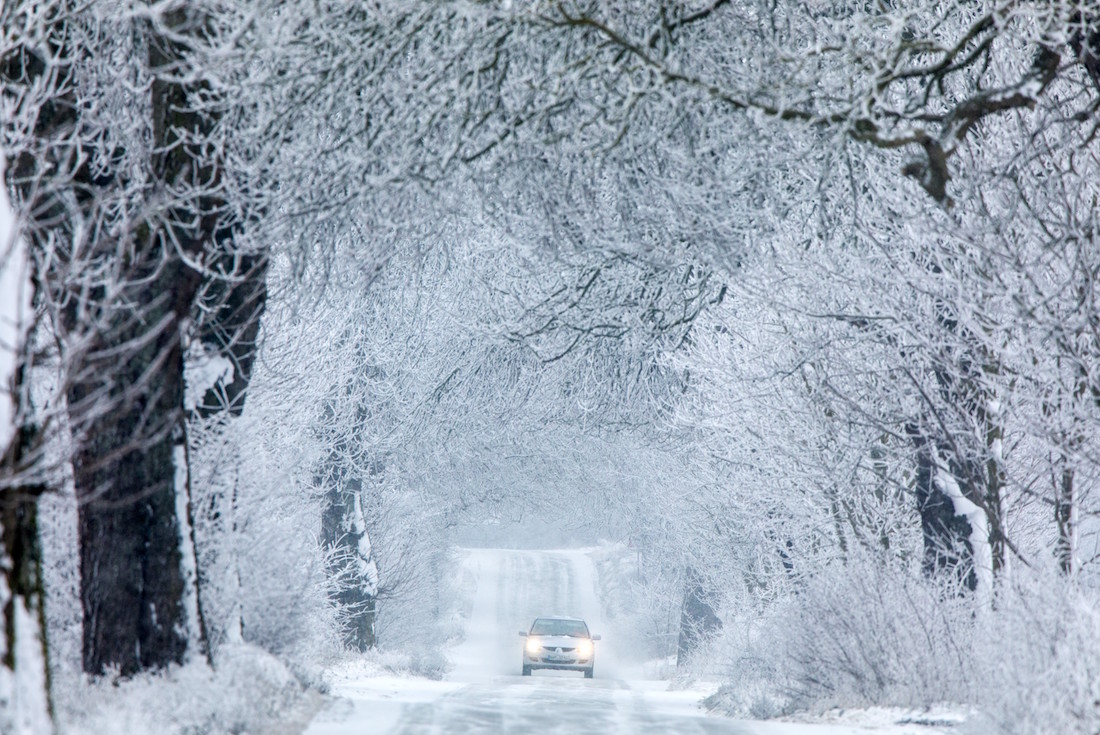 A picture taken on January 21, 2019 in Gadebusch shows a car driving on a snow-covered road. (Photo by Jens B¸ttner / dpa / AFP) / Germany OUT