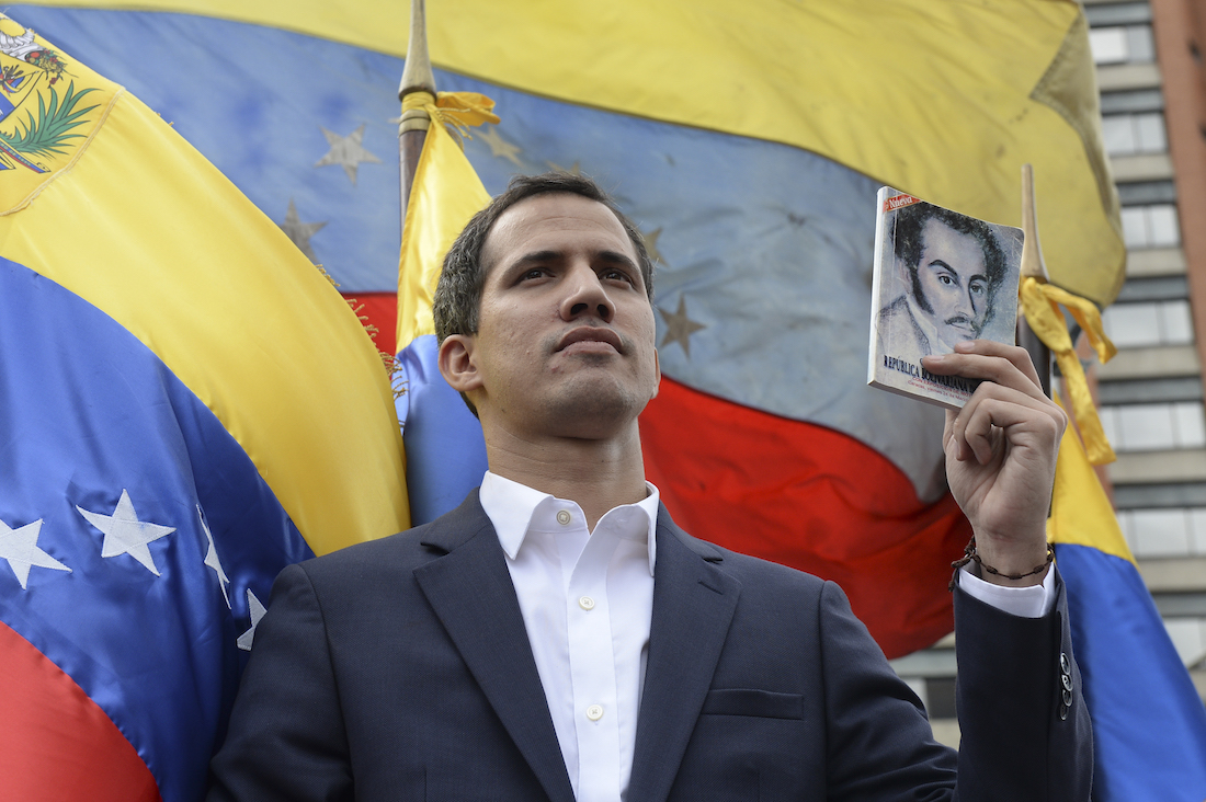 Venezuela's National Assembly head Juan Guaido declares himself the country's "acting president" during a mass opposition rally against leader Nicolas Maduro, on the anniversary of a 1958 uprising that overthrew military dictatorship in Caracas on January 23, 2019. - Moments earlier, the loyalist-dominated Supreme Court ordered a criminal investigation of the opposition-controlled legislature. "I swear to formally assume the national executive powers as acting president of Venezuela to end the usurpation, (install) a transitional government and hold free elections," said Guaido as thousands of supporters cheered. (Photo by Federico PARRA / AFP)