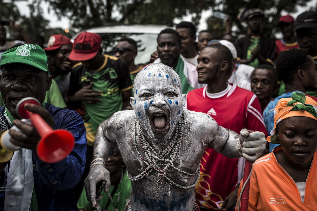 Supporters of newly elected President of the Democratic Republic of Congo Felix Tshisekedi cheer as they arrive to attend his Presidential Inauguration on January 24, 2018 in Kinshasa. - Tshisekedi took the oath of office before receiving the national flag and a copy of the constitution from outgoing president Joseph Kabila, stepping aside after 18 years at the helm of sub-Saharan Africa's biggest country, marking the country's first-ever peaceful handover of power after chaotic and bitterly-disputed elections. (Photo by John WESSELS / AFP)