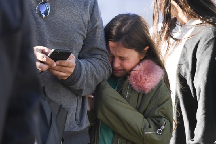 A young girl reacts as police officers secure an area following a shooting incident in New York on October 31, 2017.  Several people were killed and numerous others injured in New York on Tuesday after a vehicle plowed into a pedestrian and bike path in Lower Manhattan, police said. "The vehicle struck multiple people on the path," police tweeted. "The vehicle continued south striking another vehicle. The suspect exited the vehicle displaying imitation firearms & was shot by NYPD."  / AFP PHOTO / Don EMMERT